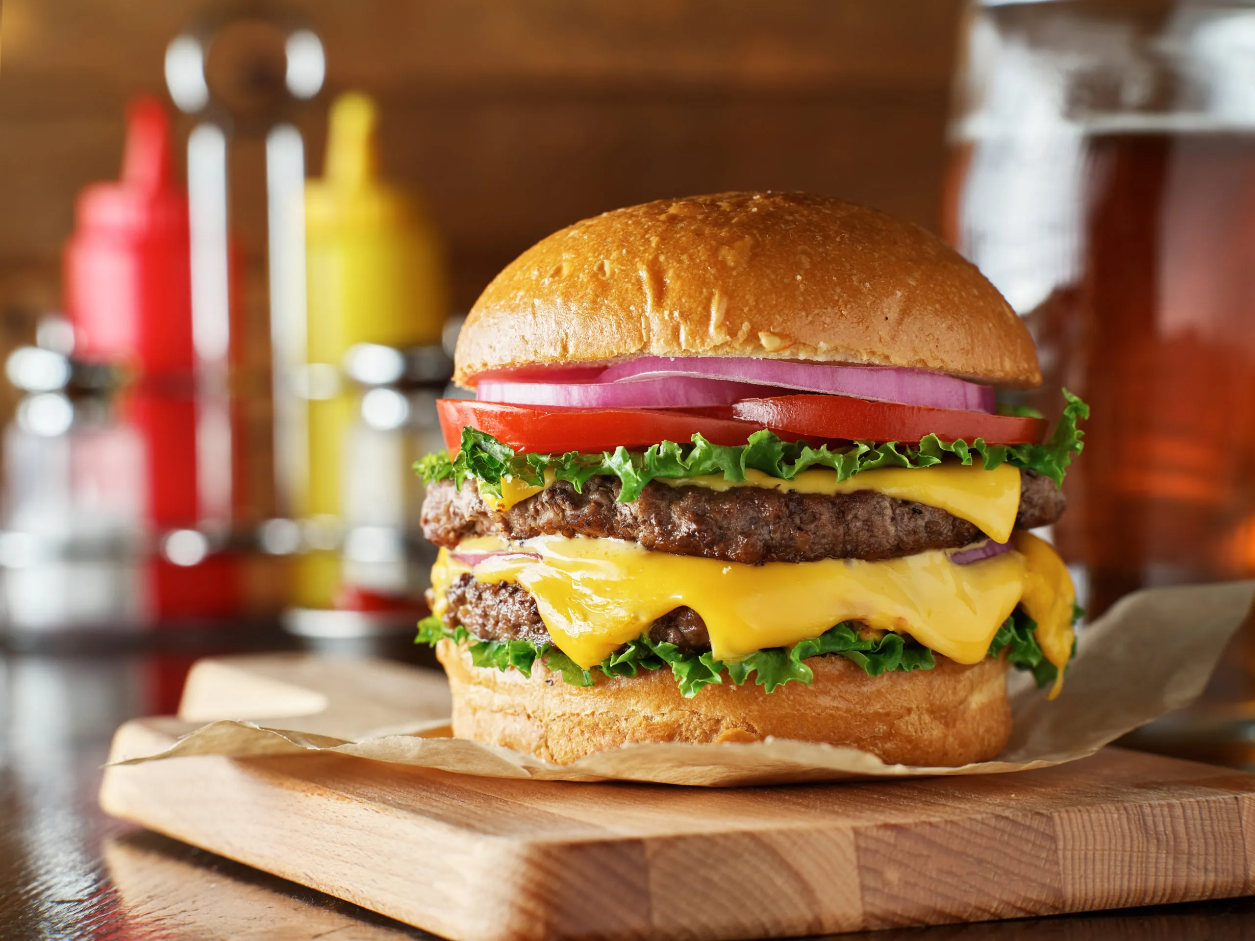 delicious-double-cheeseburger-on-wooden-board-scaled-1.webp