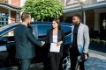 business-people-shaking-hands-finishing-up-meeting-caucasian-man-and-woman-shaking-hands-african-man-coworker-stands-and-holds-tablet-meeting-outdoors-near-the-car-1024x683-1.jpg