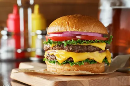 delicious-double-cheeseburger-on-wooden-board-scaled-1.webp